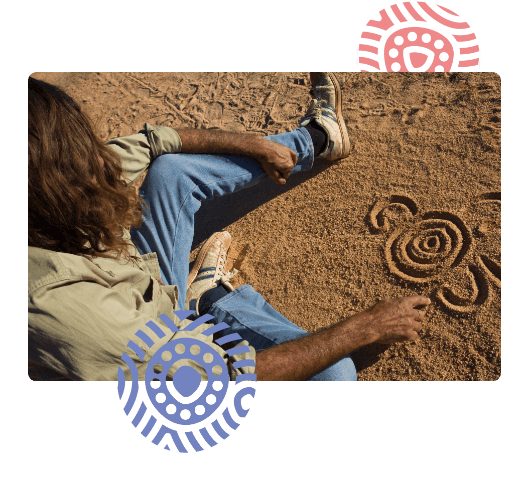 Man draws pattern in sand