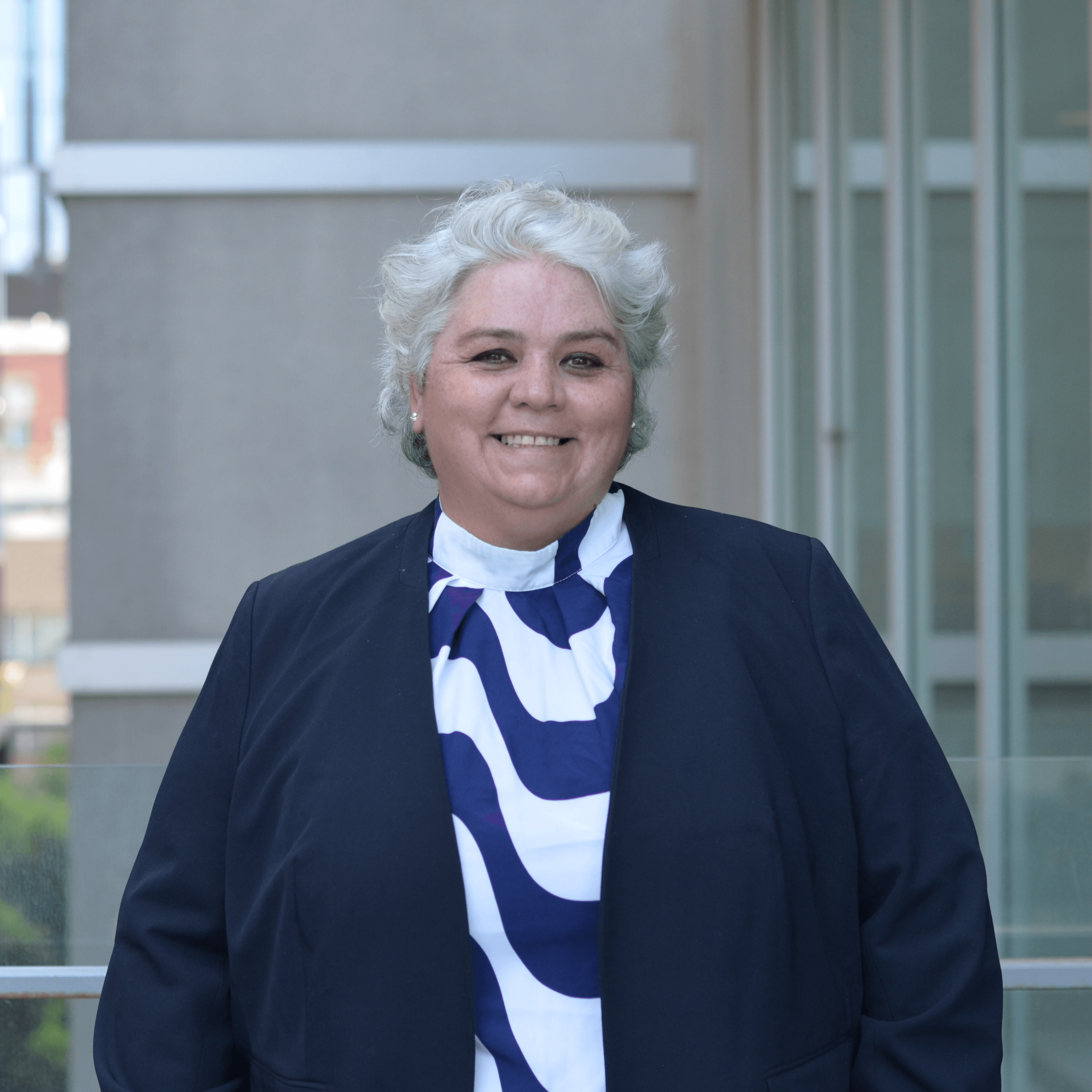 Professor Melitta Hogarth, Director Professor Melitta Hogarth in a blue striped blouse outside of the Faculty of Education