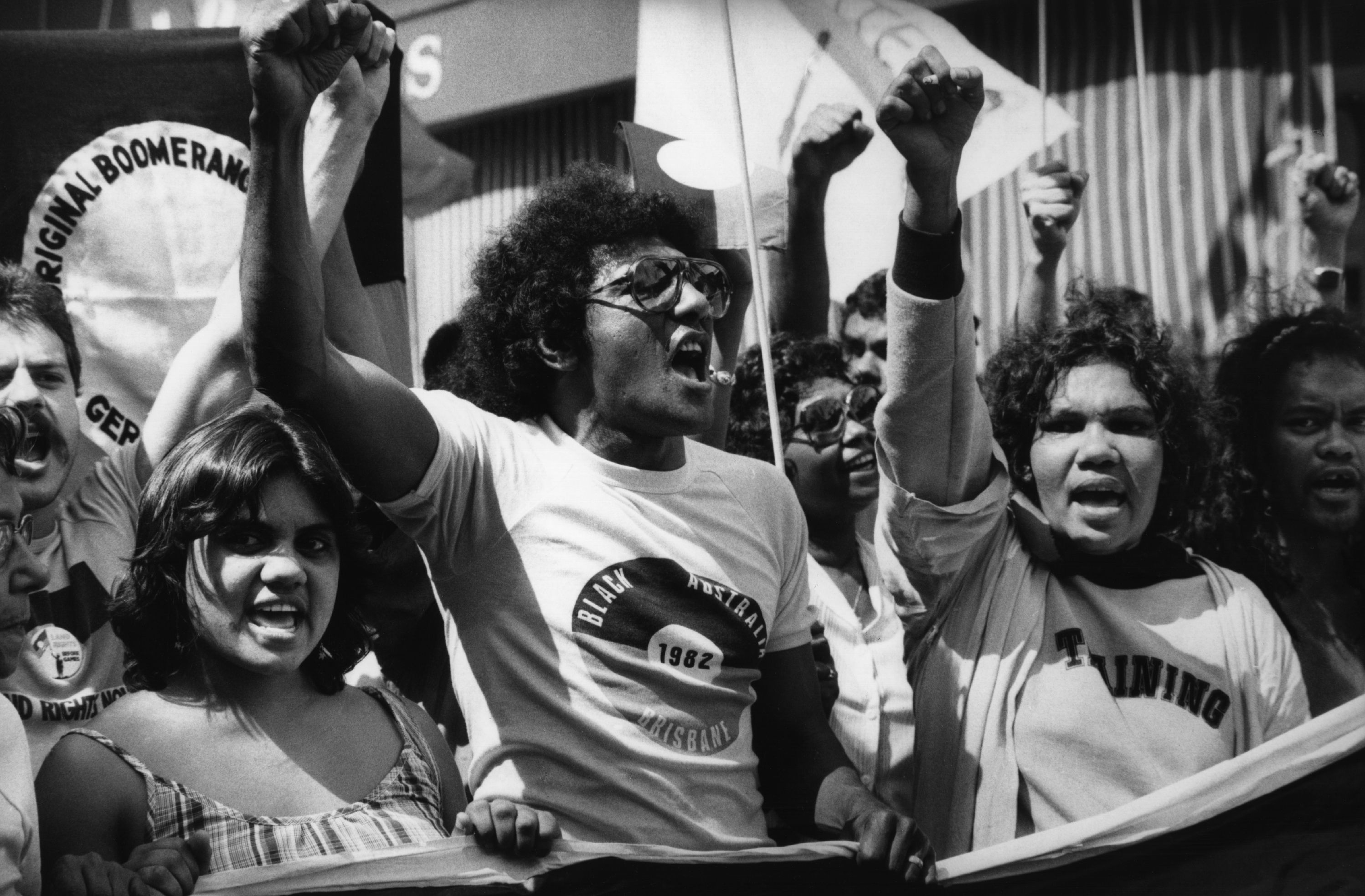 Aboriginal Land Rights Demonstration at the Commonwealth Games. Brisbane, Queensland. Photographer: Penny Tweedie. Black and white photo of First Nations people protesting
