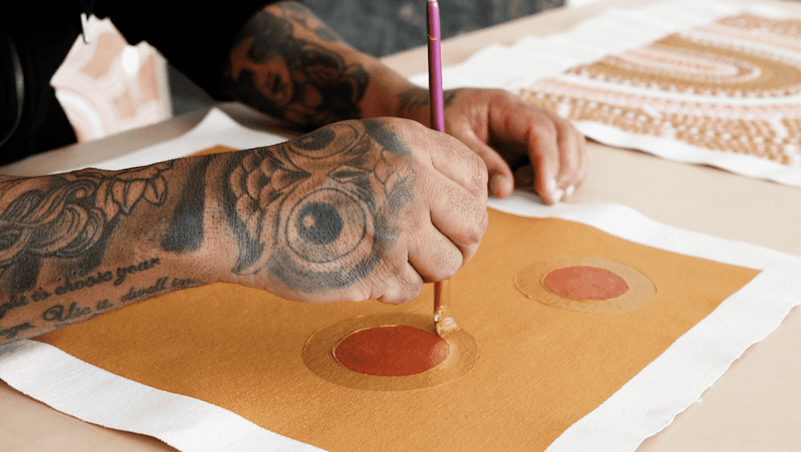Tattooed hand paints circles