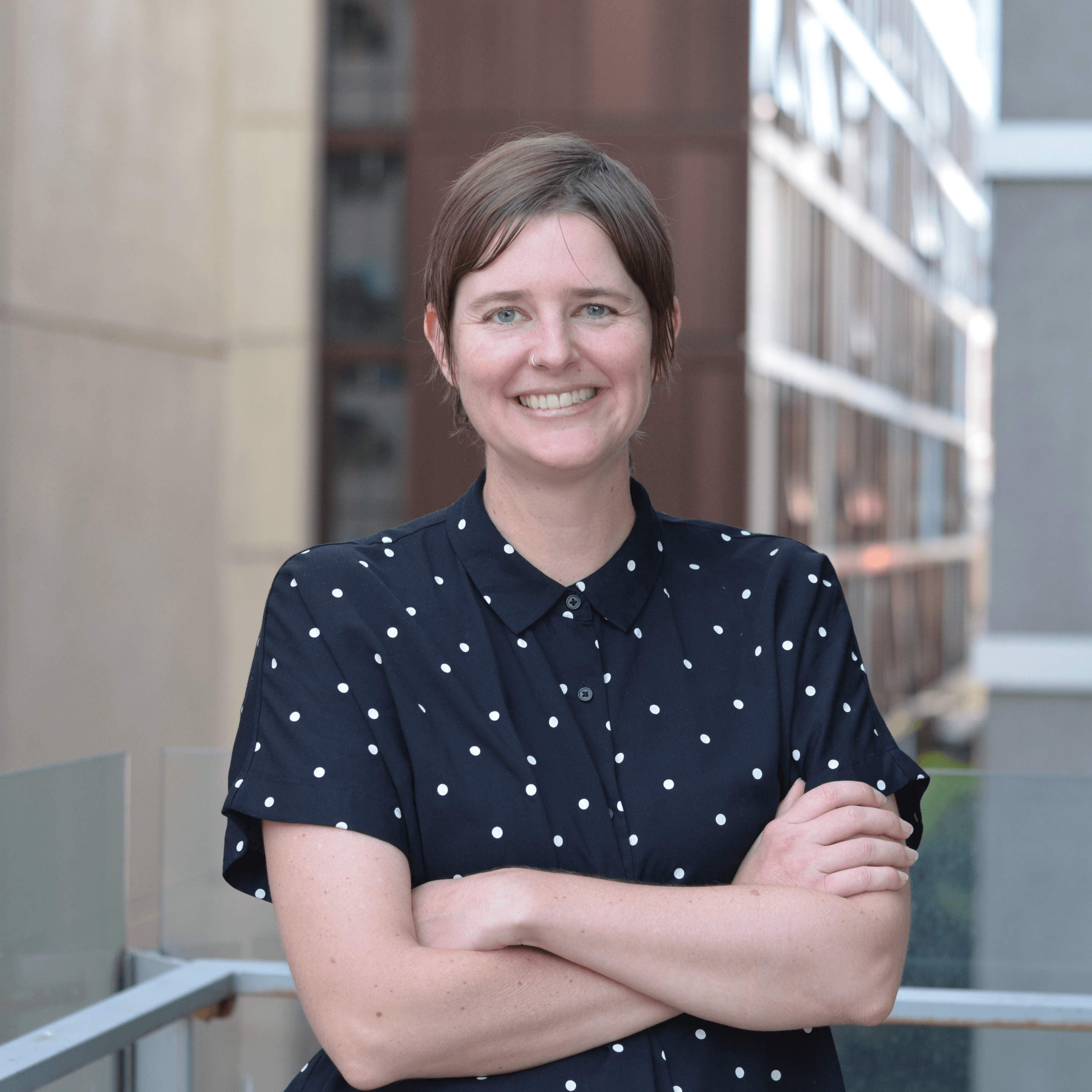 Dr Lucy Buzacott, Program Manager Dr Lucy Buzacott, Program Manager in blue spotty shirt outside the Faculty of Education
