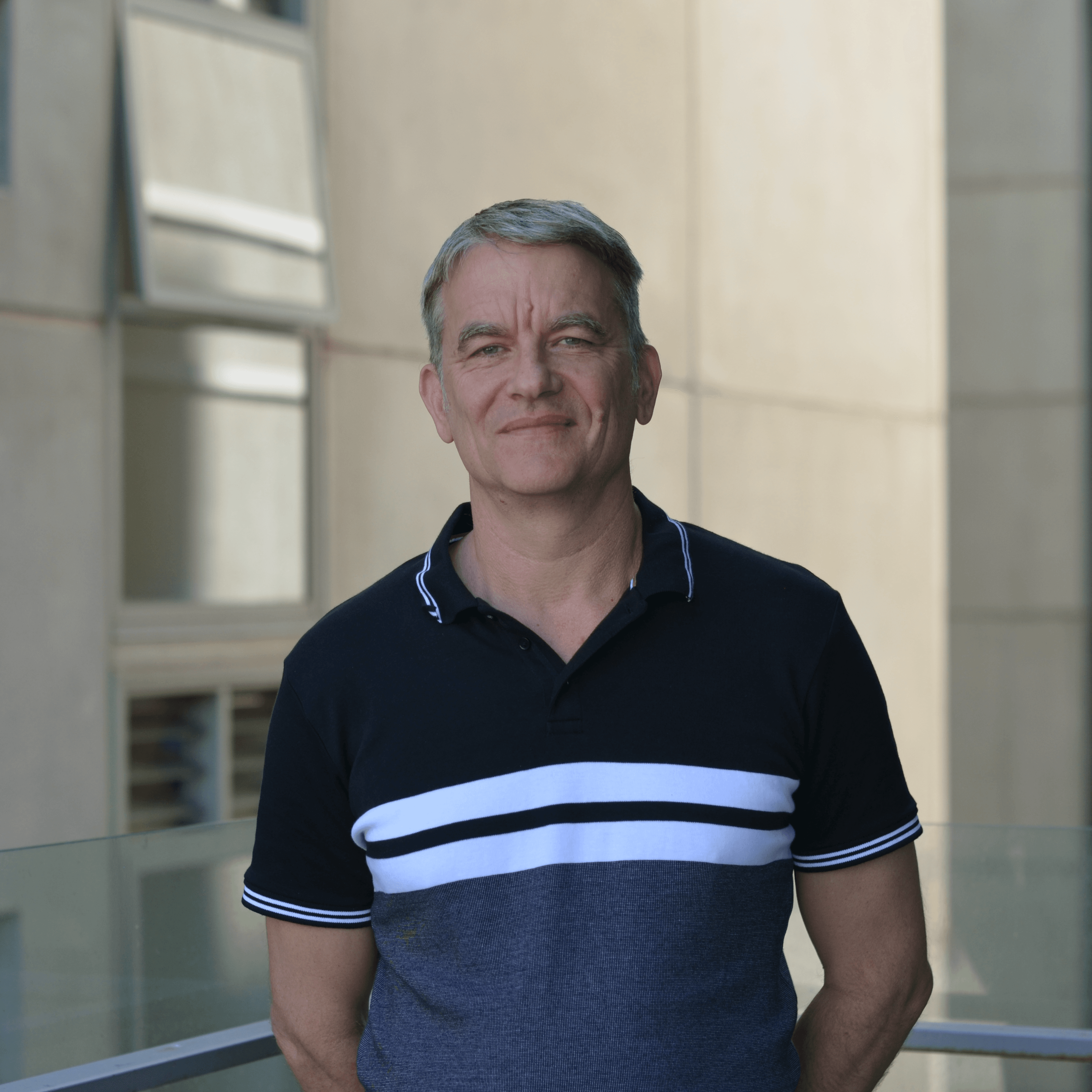 Dr Michael Tynan, Engagement and Partnerships Manager IMAGE Dr Michael Tynan in blue and black top outside the Faculty of Education