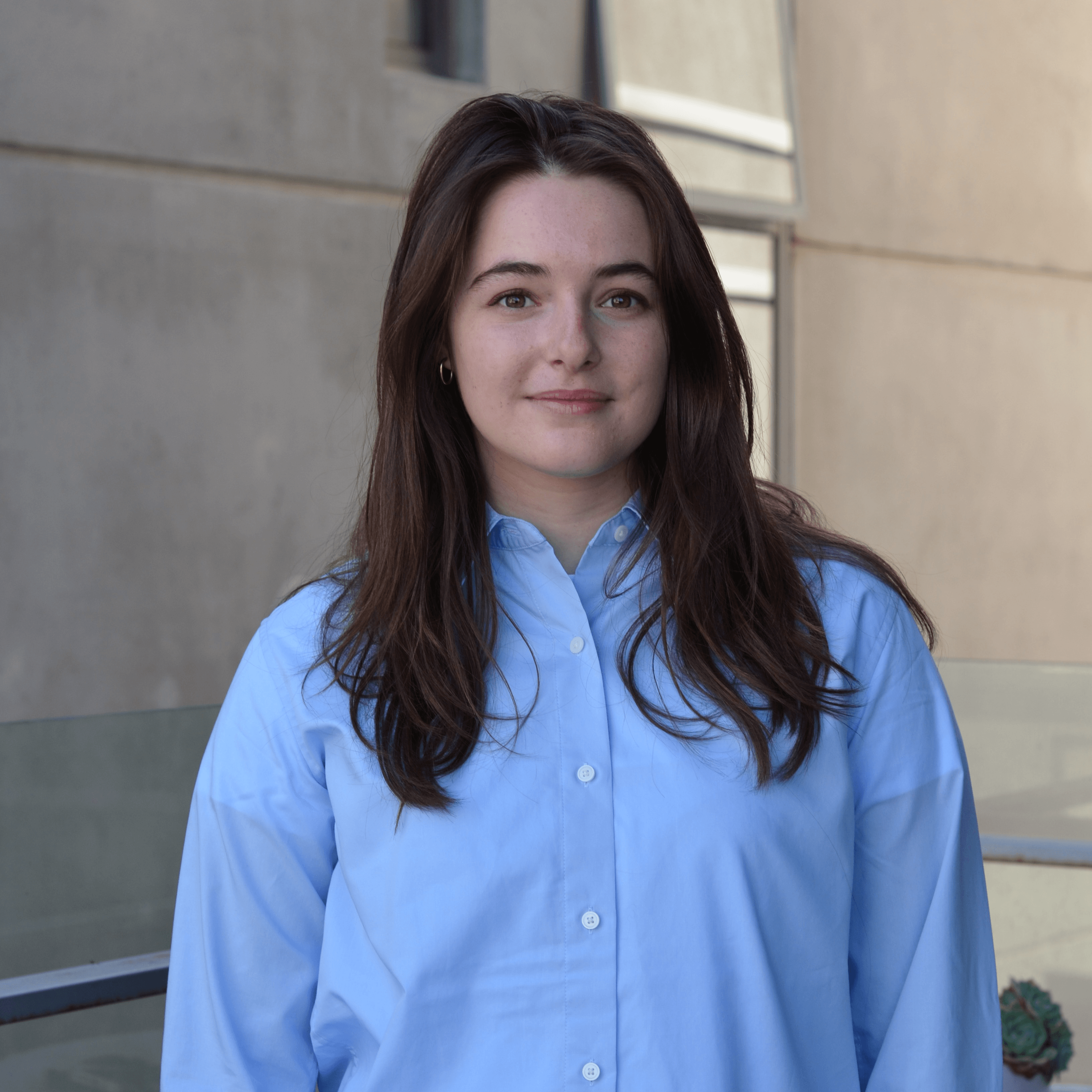 India Murphy, Digital Engagement Officer IMAGE India Murphy wearing blue shirt outside the Faculty of Education