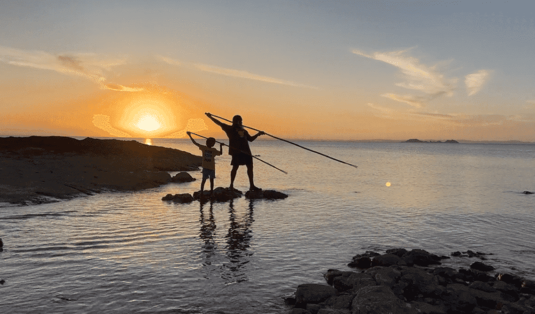 Banner fishing Man and boy spearfish
