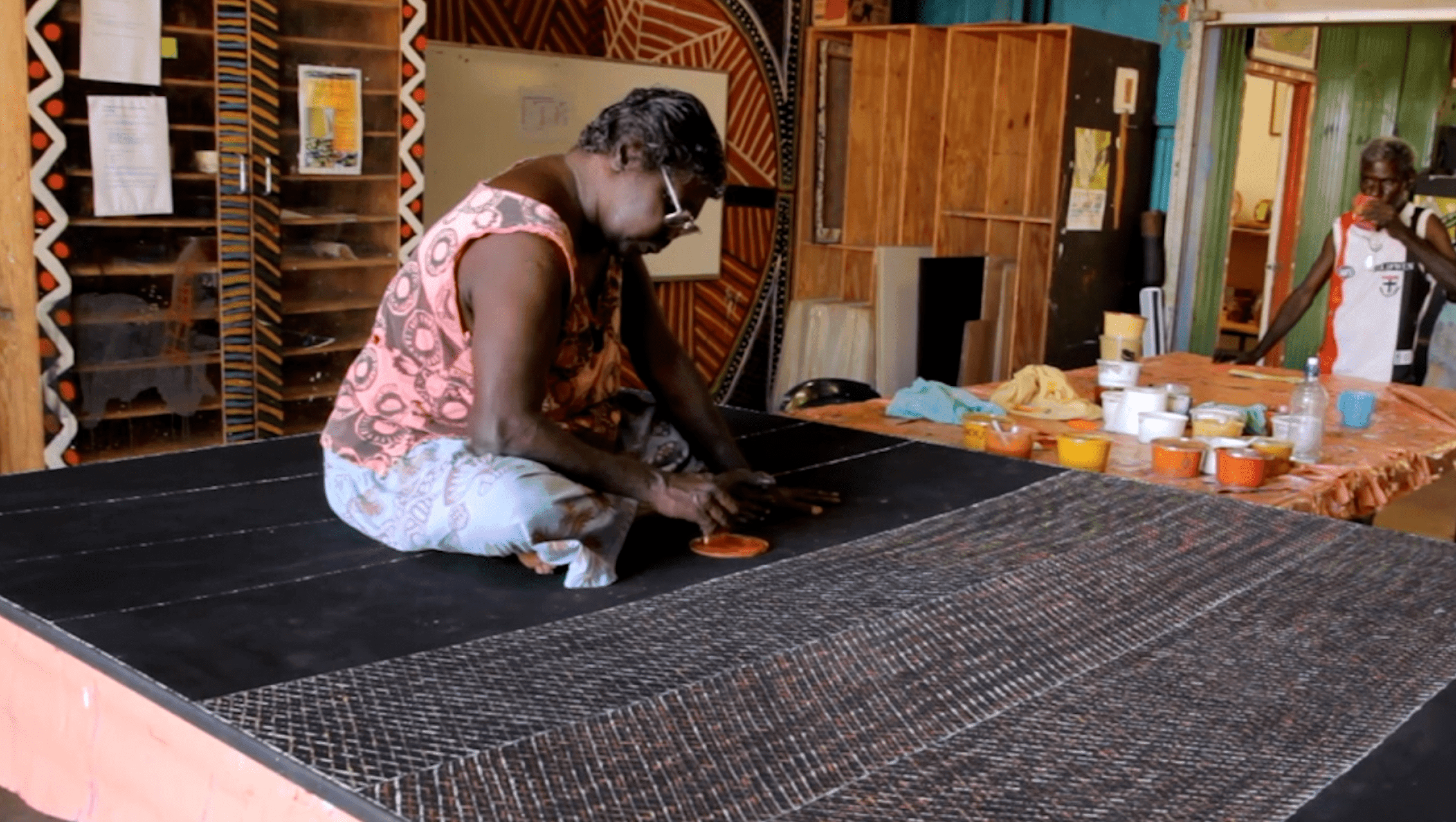 PD video -4 beyond deficit Woman sits cross-legged and paints
