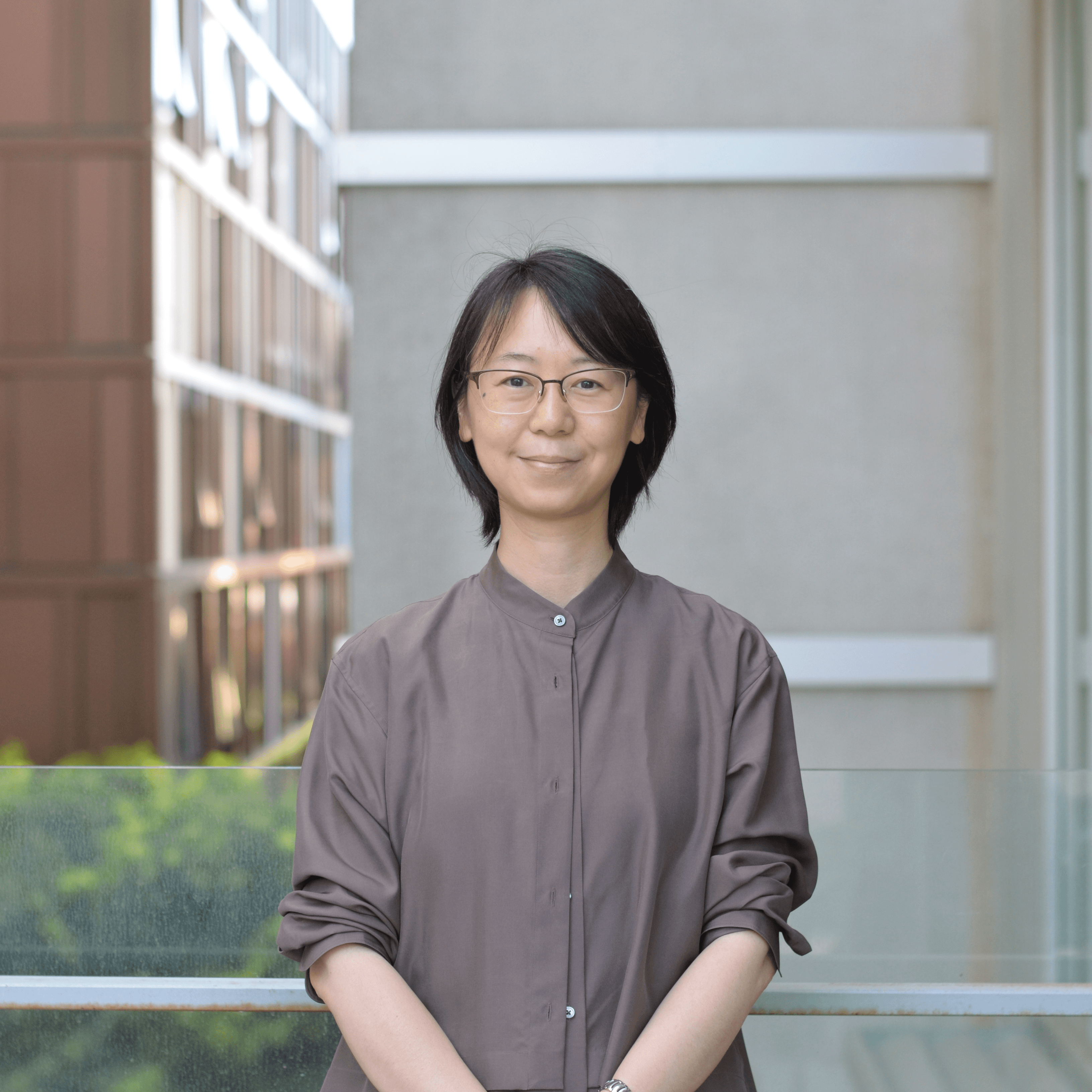 Suowa Zhang, Research Assistant Suowa Zhang in brown shirt outside at the Faculty of Education