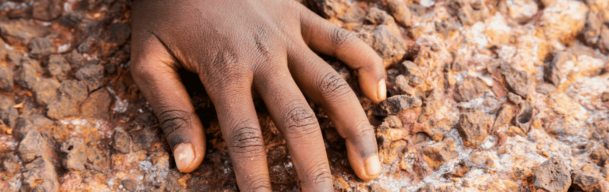 place.png A child's hand along a rock face