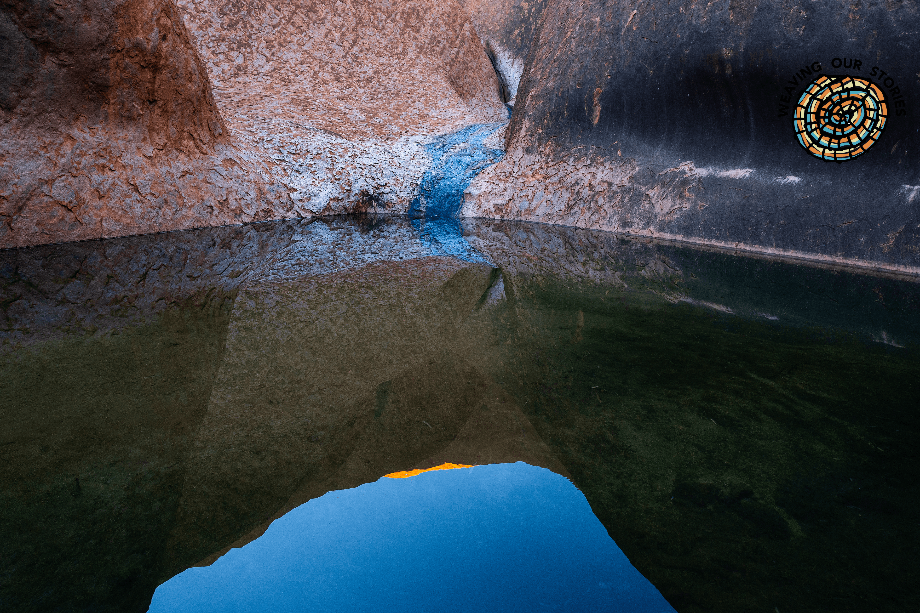WOS LOGO Mutitjulu Wateringhole at Uluru. Uluru- Kata Tjuṯa National Park, Northern Territory. Photographer Steve Christo. Source Getty Images. Used under Licence Mutitjulu Wateringhole at Uluru with wos logo